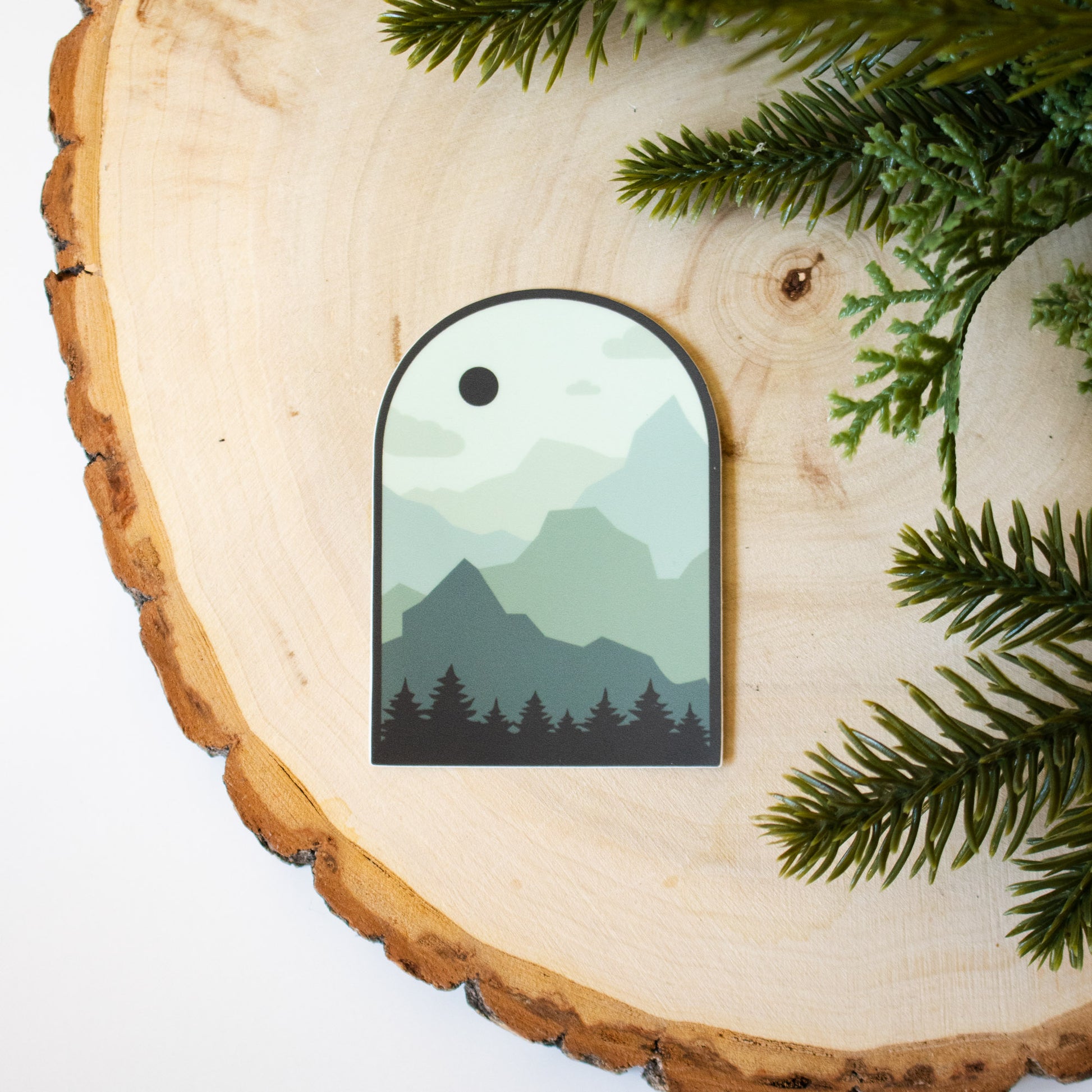 Mountain silhouette design in varying shades of a forest green 